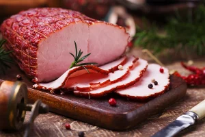 formed ham on cutting board